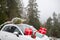 Car with Christmas tree decorated with presents