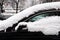 Car covered with fresh snow. snowstorm, poor visibility