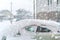 A car covered stands in an open parking lot.