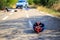 Car crash with the injured person and bicycle helmet on road