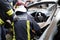 Car Crash Traffic Accident. Firefighters Rescue Injured Trapped Victims. Firemen give First Aid to passengers.