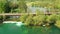 Car crossing road bridge over Mreznica river in Croatia, overhead shot of countryside landscape