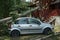 A car damaged by hurricane with fallen tree on the house and car