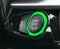 Car dashboard with focus on Green engine start stop button. Modern car interior details. Car detailing.