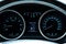 Car dashboard with instruments and dial speedometer tachometer, fuel gauge, engine temperature, oil temperature, ammeter with blue