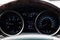 Car dashboard with instruments and dial speedometer tachometer, fuel gauge, engine temperature, oil temperature, ammeter with blue