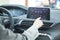 Car dashboard. Radio closeup. Woman sets up air conditioning