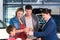 Car dealer giving key to new auto to family