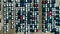 Car dealer parking lot full of new automobiles. Aerial shot of cars at a car dealer parking lot.