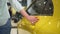 Car dealership, woman walk and touch yellow sedan auto closeup Spbas. Buyer hand on new vehicle