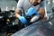 Car detailing. Male hands with orbital polisher in auto repair shop