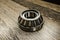 Car differential bearings on wooden background