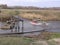 A car with difficulty passes through the river on a flooded road after the spring flood in Siberia