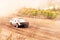 Car on dirt track. Racing cars in the fresh air with dust.