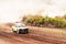 Car on dirt track. Racing cars in the fresh air with dust.