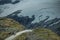 Car on the Dramatic Alpine Road with Glaciers