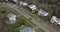 Car drives on curvy two-lane road built in small village