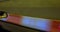 Car drives fast along road past railings with glowing lamps
