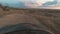 the car drives over rough terrain, POV view. Dirt road through fields