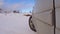 Car drives on snow covered hill in winter. Driving a race car on a snowy road