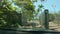 Car drives trough automatic security gate on a palm tree lined road