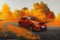 A car driving along a road strewn with autumn foliage