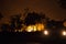 car driving away from a bushfire, forest is really bright because of the fire, litchfield national park, australia