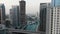 Car is driving on a bridge over Dubai Creek, aerial footage, skyscrapers, 4k