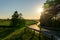 Car driving curvy road on the countryside during sunset