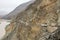 Car driving on dangerous mountain road in Nubra valley surrounded by Himalayas in Ladakh