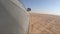 Car is driving in the desert. Camera from the car`s right side