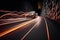 a car driving down a road at night with lights on it\\\'s headlights and a blurry image of a car