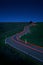 Car Driving Down a Winding Country Road, long exposure, Taillights in blurred motion