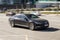 Car driving fast motion on the highway, front side view. Black Volkswagen Passat B8 is moving on the street