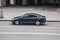 Car driving fast motion on the highway, side view. Gray Volkswagen Passat B8 is moving on the street