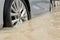 Car driving on a flooded road, The broken car is parked in a flooded road