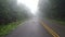 Car driving of foggy mountain road northern of thailand