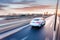 Car driving on freeway at sunset, motion blur