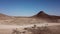 Car driving on gravel road in aerial desert. Sandy landscape, nobody in Namibia.