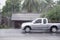 Car driving motion through gale rain on front wooden house