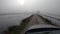 Car driving over a muddy road in the autumn countryside on a gloomy day