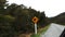 Car driving past a kiwi road sign