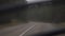 Car driving on the road in nature on a cloudy day. Driving through pine forest landscape