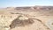 Car driving on a road in the Negev Desert near Mitzpe Ramon, Israel.