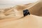 Car driving in Rub al Khali Desert at the Empty Quarter, in Abu