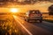 A car driving on a scenic road during a beautiful sunset, capturing the tranquil journey into the twilight