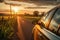 A car driving on a scenic road during a beautiful sunset, capturing the tranquil journey into the twilight