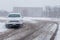 Car driving in slippery snow road