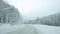 Car driving on snow road during snowfall in slowmotion. 1920x1080