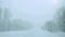 Car driving on snow road during snowfall in slowmotion. 1920x1080